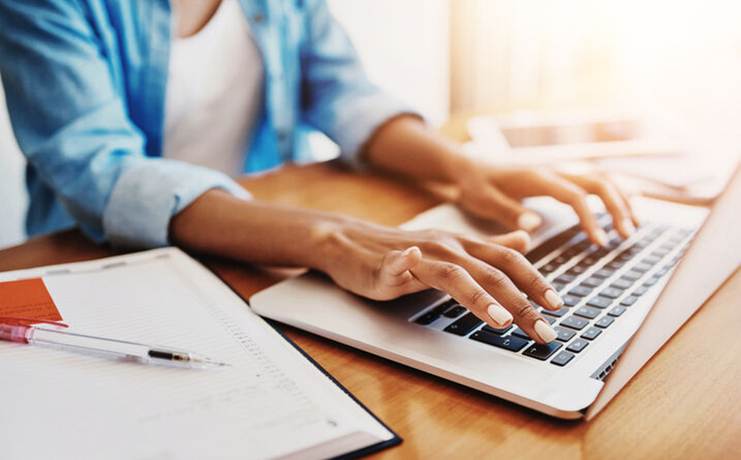 Woman typing on laptop